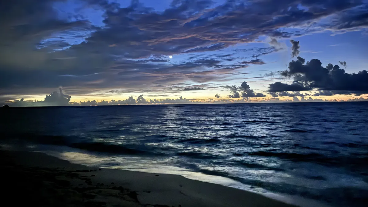 Twilight moonrise over the Caribbean Sea from the beach at Akumal